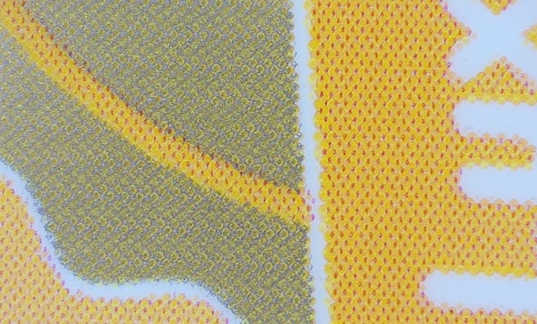 Under the microscope X 60 close-up of the gold achieved with overlapping of colors perceived as one color by the human eye